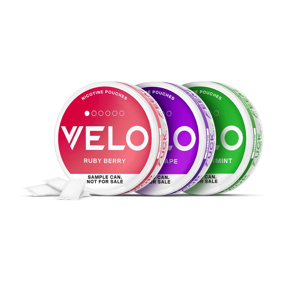 Velo Nicotine Pouches |  Three round cans of VELO nicotine pouches in Ruby Berry, Purple Grape, and Mint flavors. Each can is open with nicotine pouches visible, and labeled SAMPLE CAN. NOT FOR SALE on a white background.