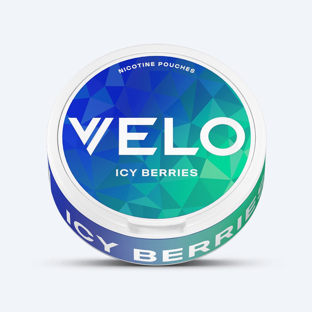 Velo Nicotine Pouches |  A round container of VELO Icy Berries nicotine pouches, featuring a blue and green geometric patterned lid, delivers a refreshing triple-berry blend with a minty cooling effect.