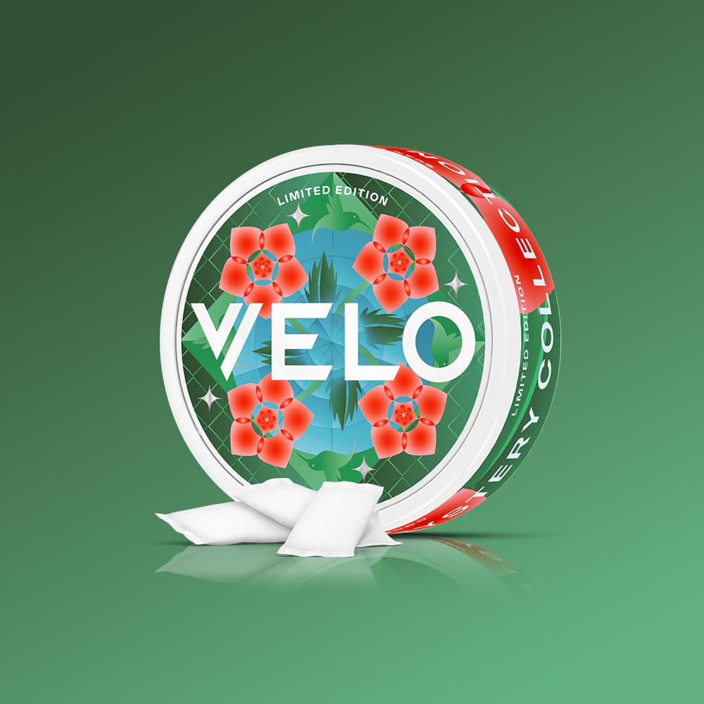 Velo Nicotine Pouches |  Round VELO GB Mystery Collection Bundle tin featuring a green geometric pattern with red flower icons, with three small white nicotine pouches resting in front.