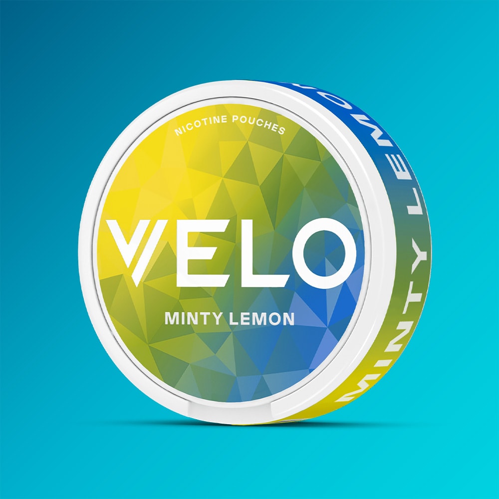 Velo Nicotine Pouches |  A round container of VELO Minty Lemon nicotine pouches, featuring a fresh minty lemon flavor with a peppermint twist. The packaging displays the product name "Minty Lemon" in white text over a blue gradient background and showcases a green and blue geometric design.