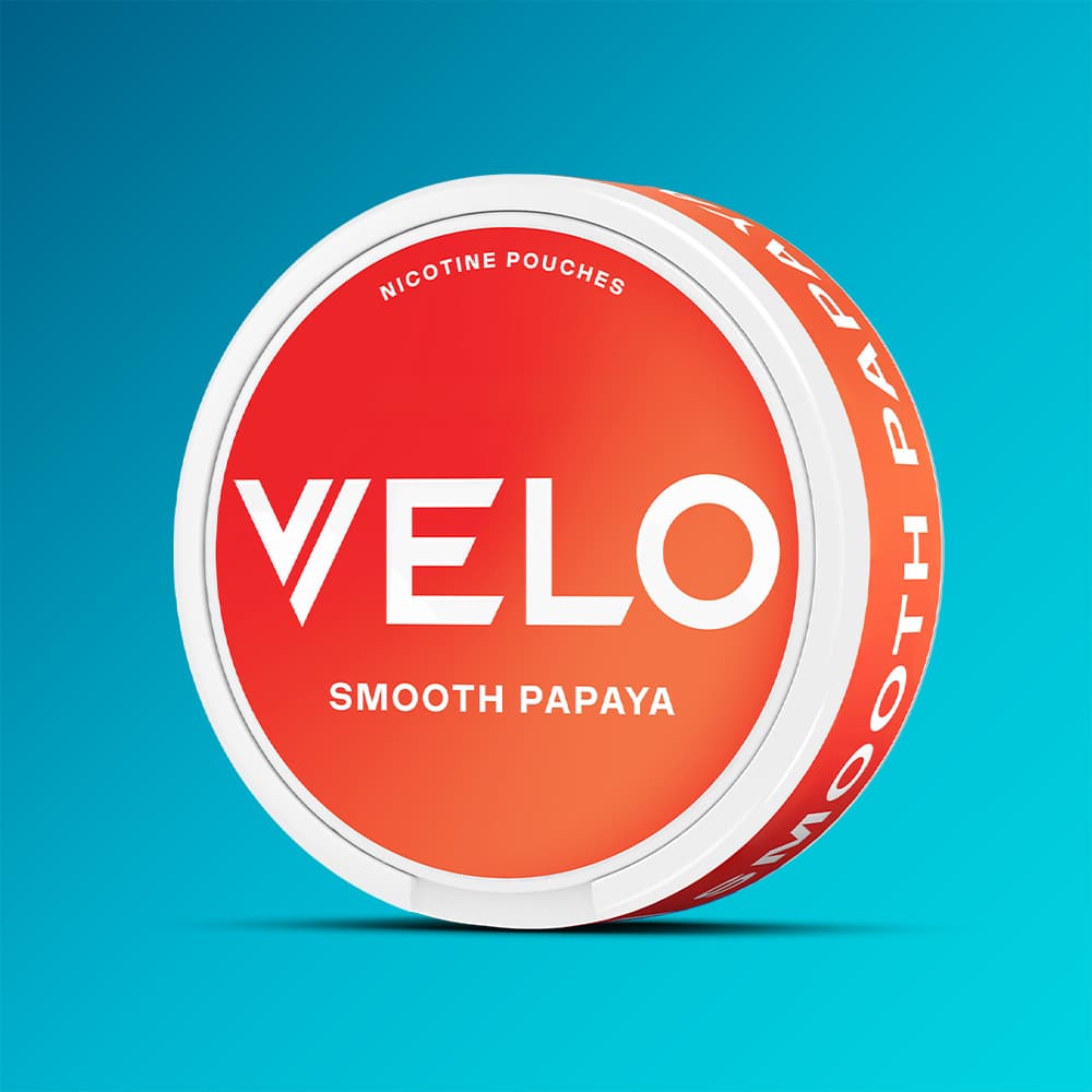 Velo Nicotine Pouches |  A round VELO Smooth Papaya container featuring a red-orange gradient design is displayed against a blue background, emphasizing the tropical papaya flavour of these nicotine pouches.