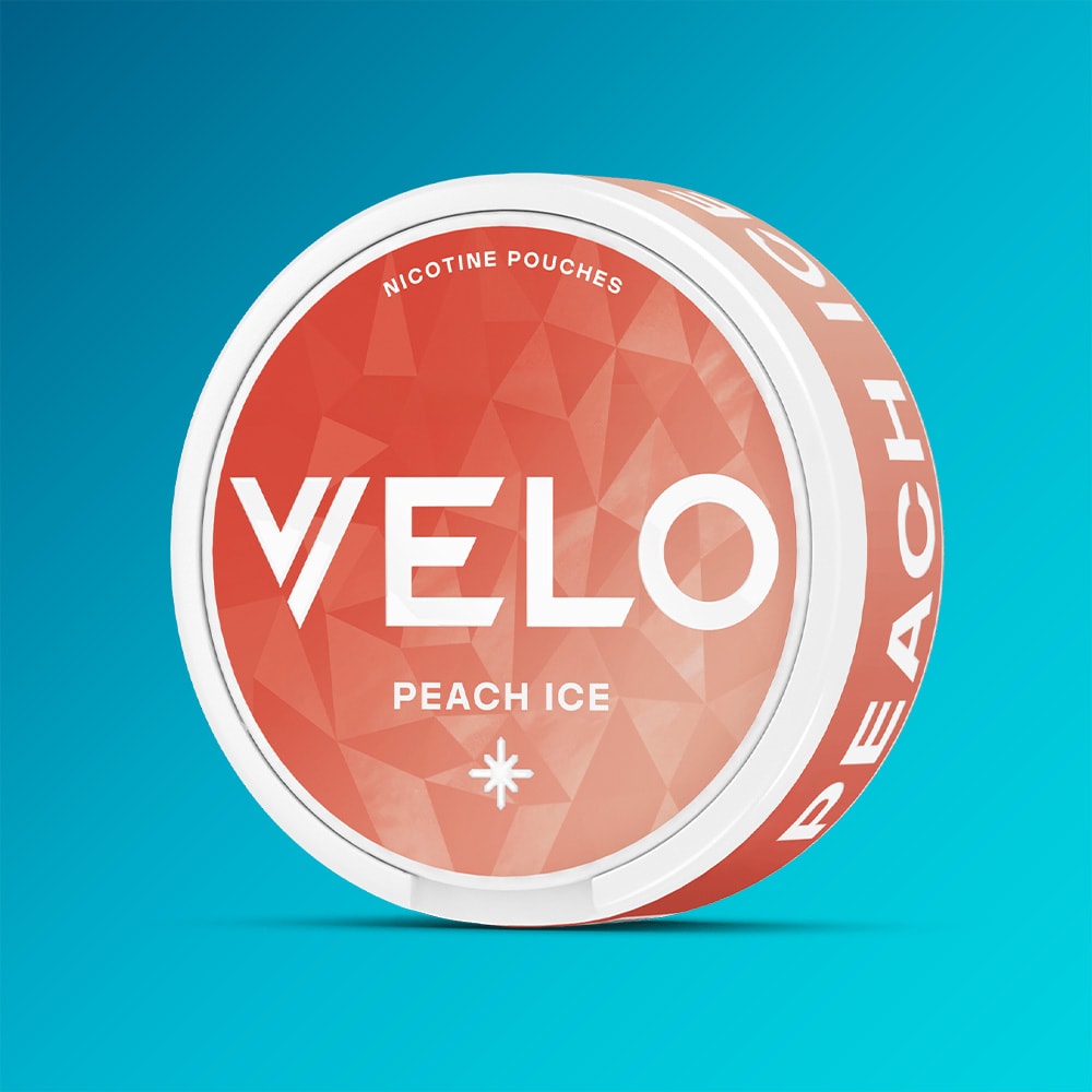 Velo Nicotine Pouches |  A round container of VELO Peach Ice sits against a blue gradient background. The orange packaging features white text and geometric designs, highlighting the refreshing flavor and vibrant peach essence of this nicotine pouch.
