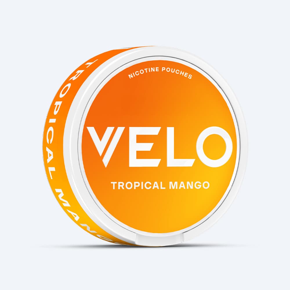 Velo Nicotine Pouches |  A round VELO Tropical Mango container showcasing an eye-catching orange and white design with bold white text on the lid, perfectly reflecting the vibrant essence of exotic fruit flavours.