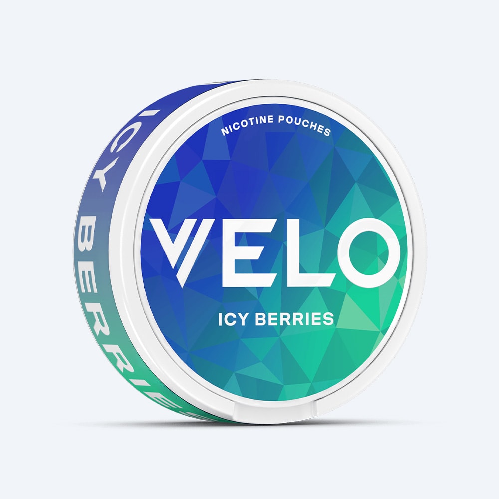 Velo Nicotine Pouches |  A round VELO container in the Icy Berries flavor features a blue and green geometric design with bold white text on both the lid and side. Each pouch delivers a refreshing cooling sensation with a triple-berry blend.