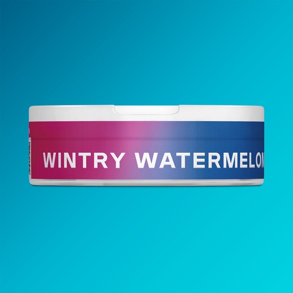 Velo Nicotine Pouches |  A round container featuring a gradient label in pink, purple, and blue displays the text "Wintry Watermelon" by VELO against a blue background—ideal for fans of VELO seeking a refreshing blend of watermelon and peppermint.