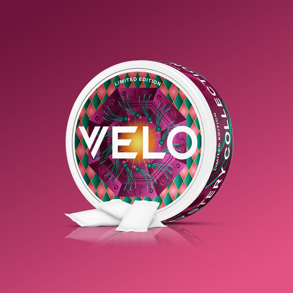 Velo Nicotine Pouches |  Round VELO GB Mystery Collection tin with a geometric pattern, featuring two white nicotine pouches in the foreground.
