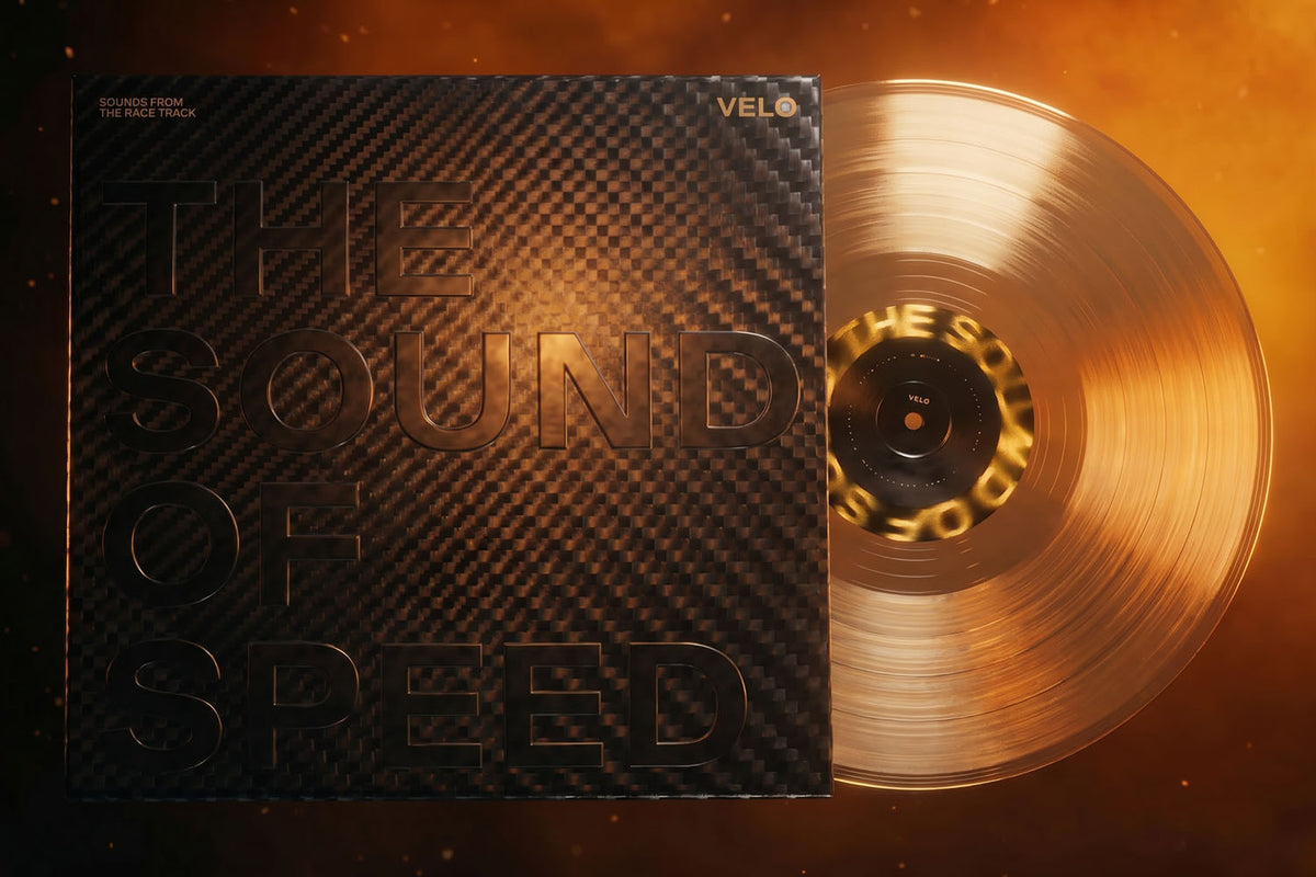 Velo Nicotine Pouches |  A gold translucent vinyl record partially slides out of a black, carbon-fiber textured sleeve with embossed text reading THE SOUND OF SPEED, reminiscent of the sleek design found in Velo nicotine pouches, set against a fiery orange background.