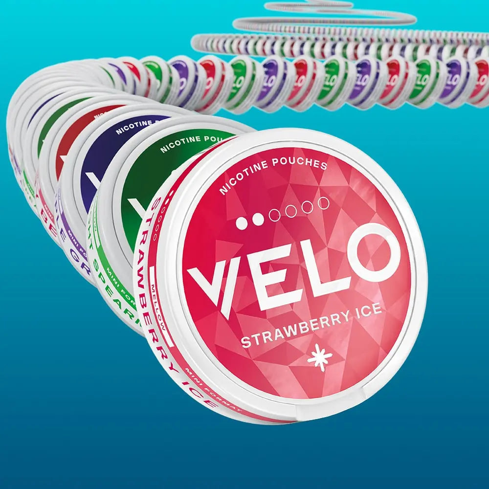 Velo Nicotine Pouches |  Several round Velo nicotine pouch containers in different flavors are arranged in a curved, domino-like sequence against a blue background, with the front container labeled Strawberry Ice in bold white text. These sleek pouches offer a convenient and flavorful way to experience nicotine on the go.