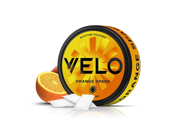 Velo Nicotine Pouches |  A round container labeled VELO Orange Spark, featuring the Velo logo, with two orange slices and three white nicotine pouches in front, on a white background. The orange and black container highlights its flavorful nicotine pouches.