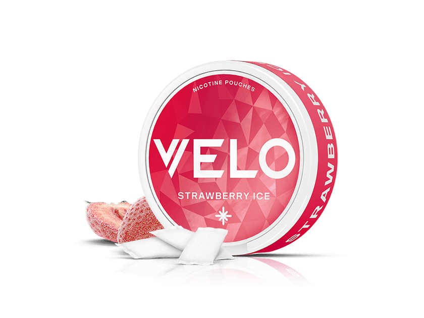 Velo Nicotine Pouches |  A round container of VELO Strawberry Ice nicotine pouches is shown with the lid open. Next to it are a sliced strawberry and two white pouches. The red container with white text showcases the refreshing Velo nicotine pouches.