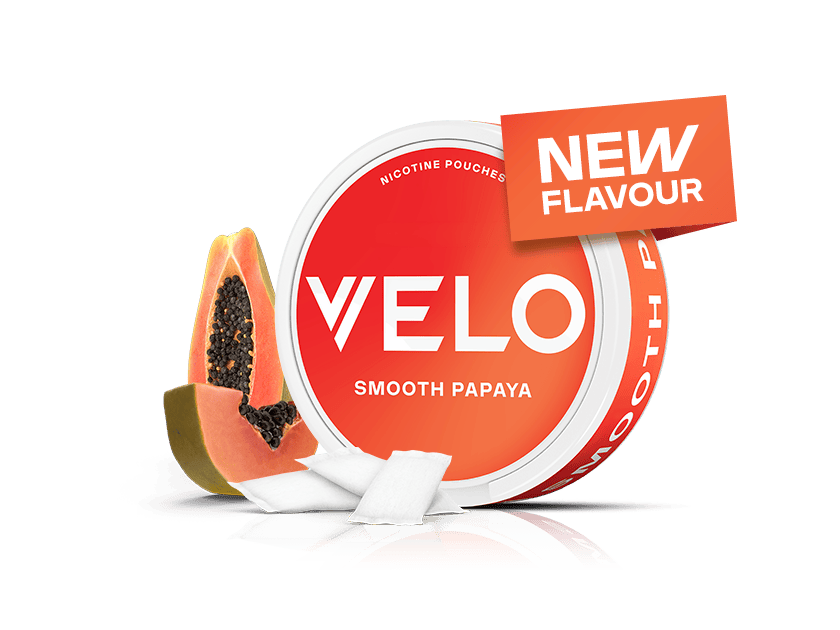 Velo Nicotine Pouches |  A round Velo container labeled VELO Smooth Papaya is shown with a NEW FLAVOUR tag, next to fresh papaya fruit slices and white nicotine pouches on a white background.