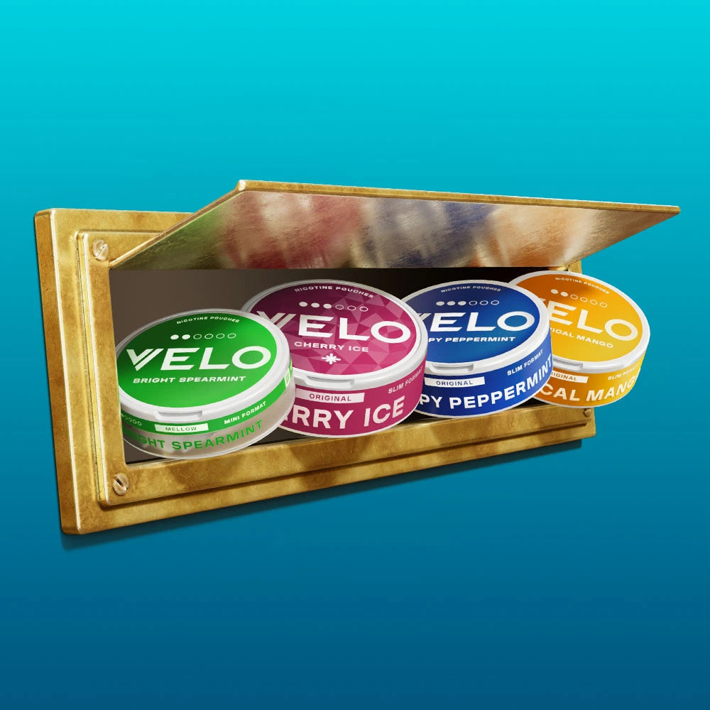 Velo Nicotine Pouches |  Four colorful VELO nicotine pouch tins—green, red, blue, and orange—are displayed on a small golden shelf with a tilted mirror above, set against a blue gradient background. Each tin highlights the vibrant range of Velo nicotine pouches.